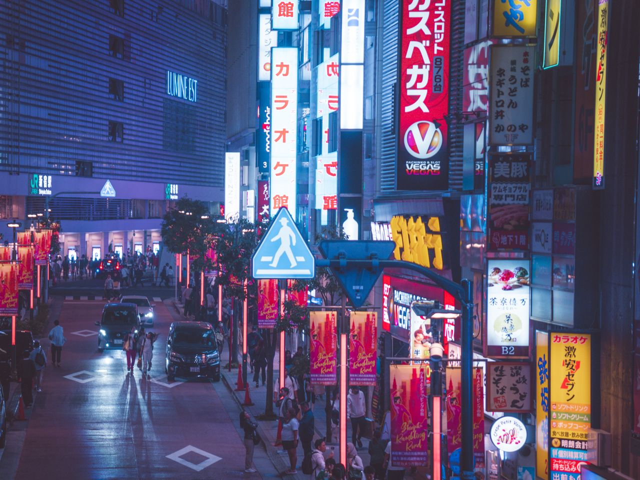 Home Explore the lively nightlife of Shinjuku, Tokyo surrounded by neon lights and bustling crowds.